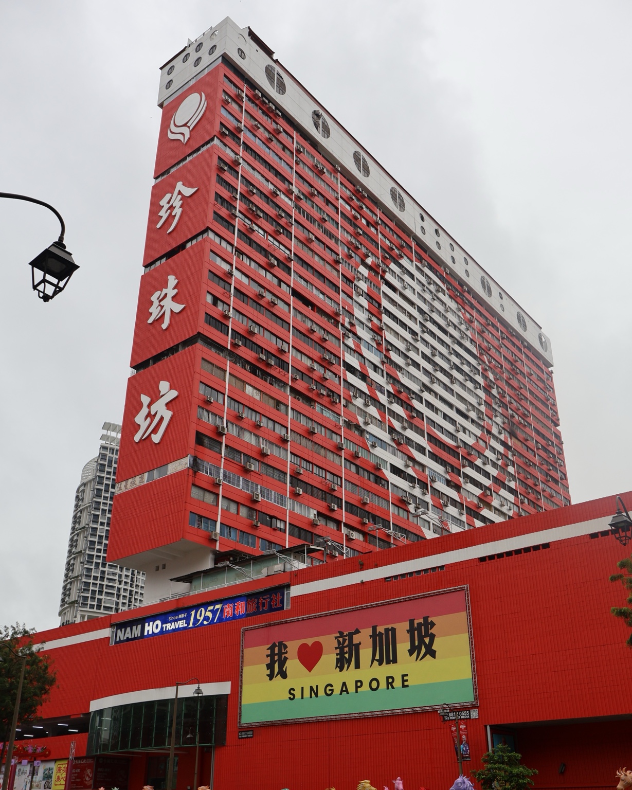 The red and white exterior of People’s Park Complex in Chinatown, Singapore